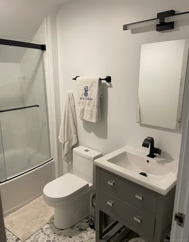 a bathroom with a sink toilet and shower