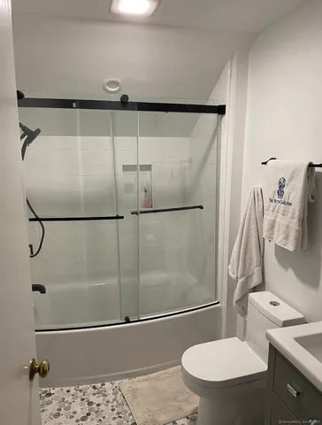 a bathroom with a sink toilet and shower