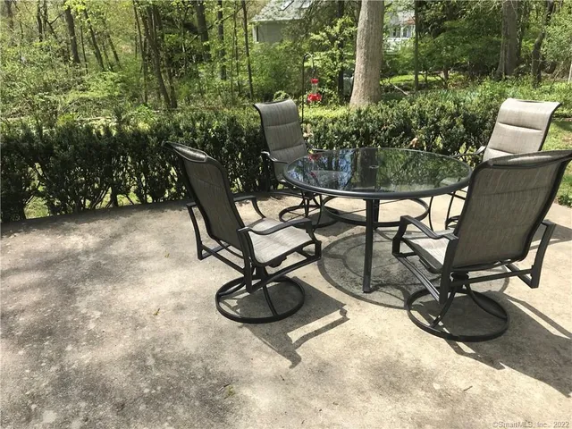 a view of a backyard with furniture and a grill