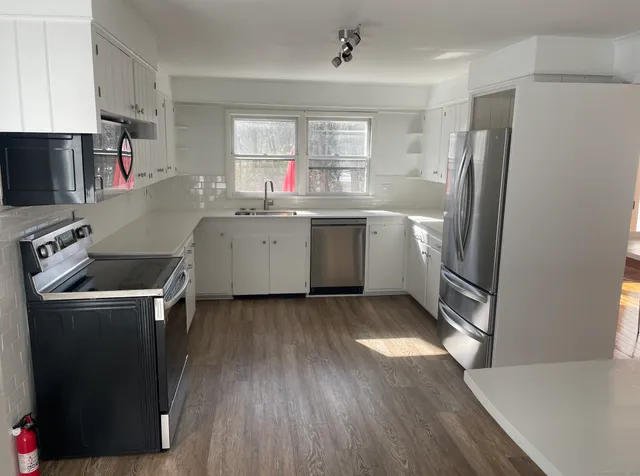 a kitchen with a refrigerator sink and stove