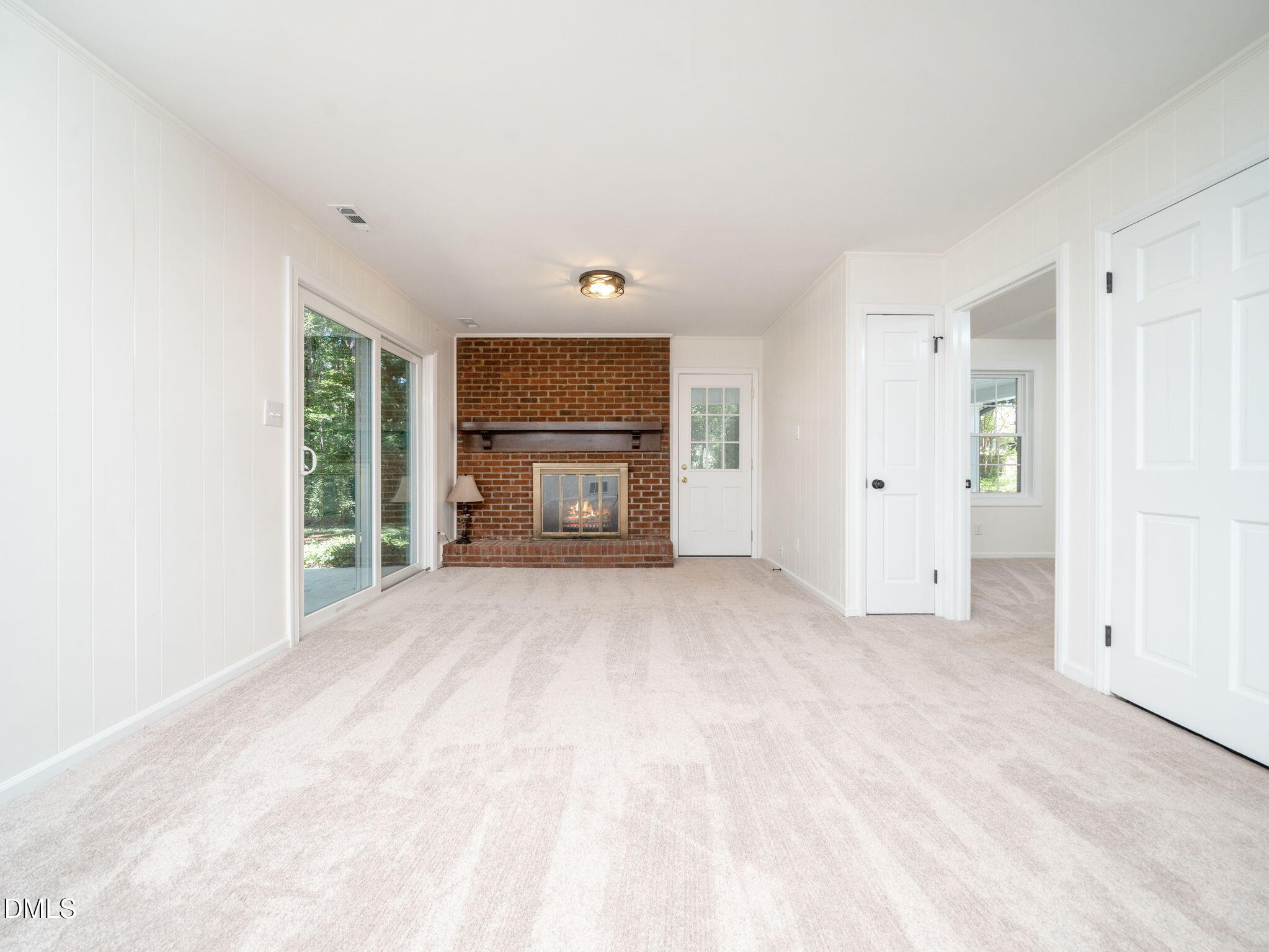 705 Villawood Court Raleigh, NC 27615 - Photo 17 of 31 The family room provides access to the back yard as well as to the carport.