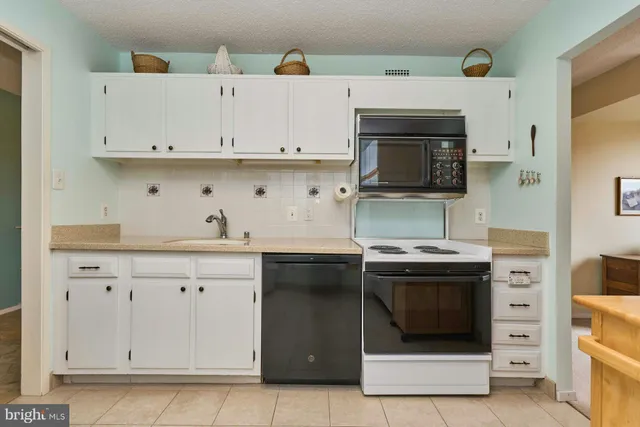 a kitchen with stainless steel appliances granite countertop a stove and a sink