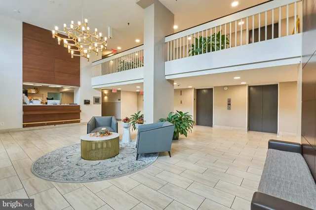 a living room with furniture and a chandelier