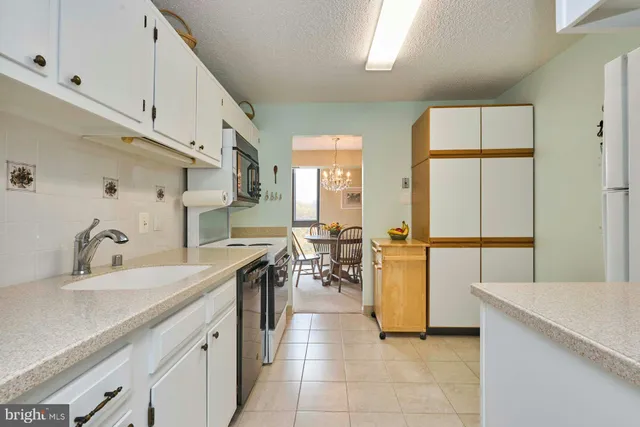 a kitchen with a sink a counter and cabinets
