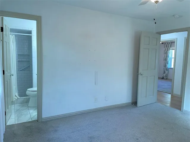 a view of a bathroom with a shower and toilet