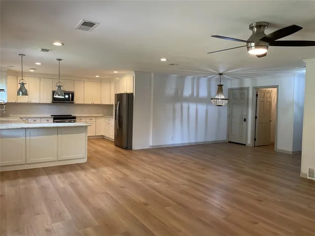 a view of kitchen with refrigerator microwave and stove