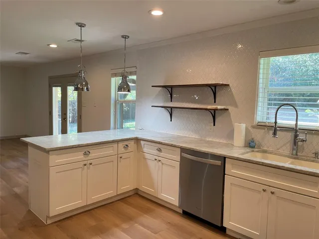 a kitchen with a sink cabinets and window