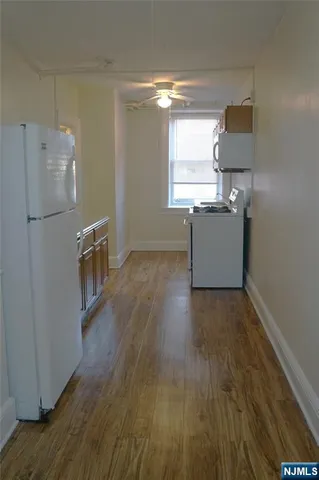 a kitchen with granite countertop a refrigerator and a stove