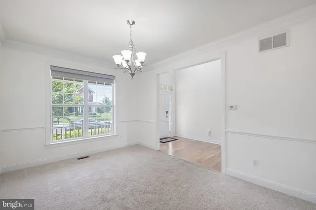 a large kitchen with stainless steel appliances granite countertop a stove a sink a refrigerator a center island and wooden floor