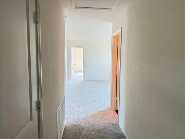 a view of a hallway with closet