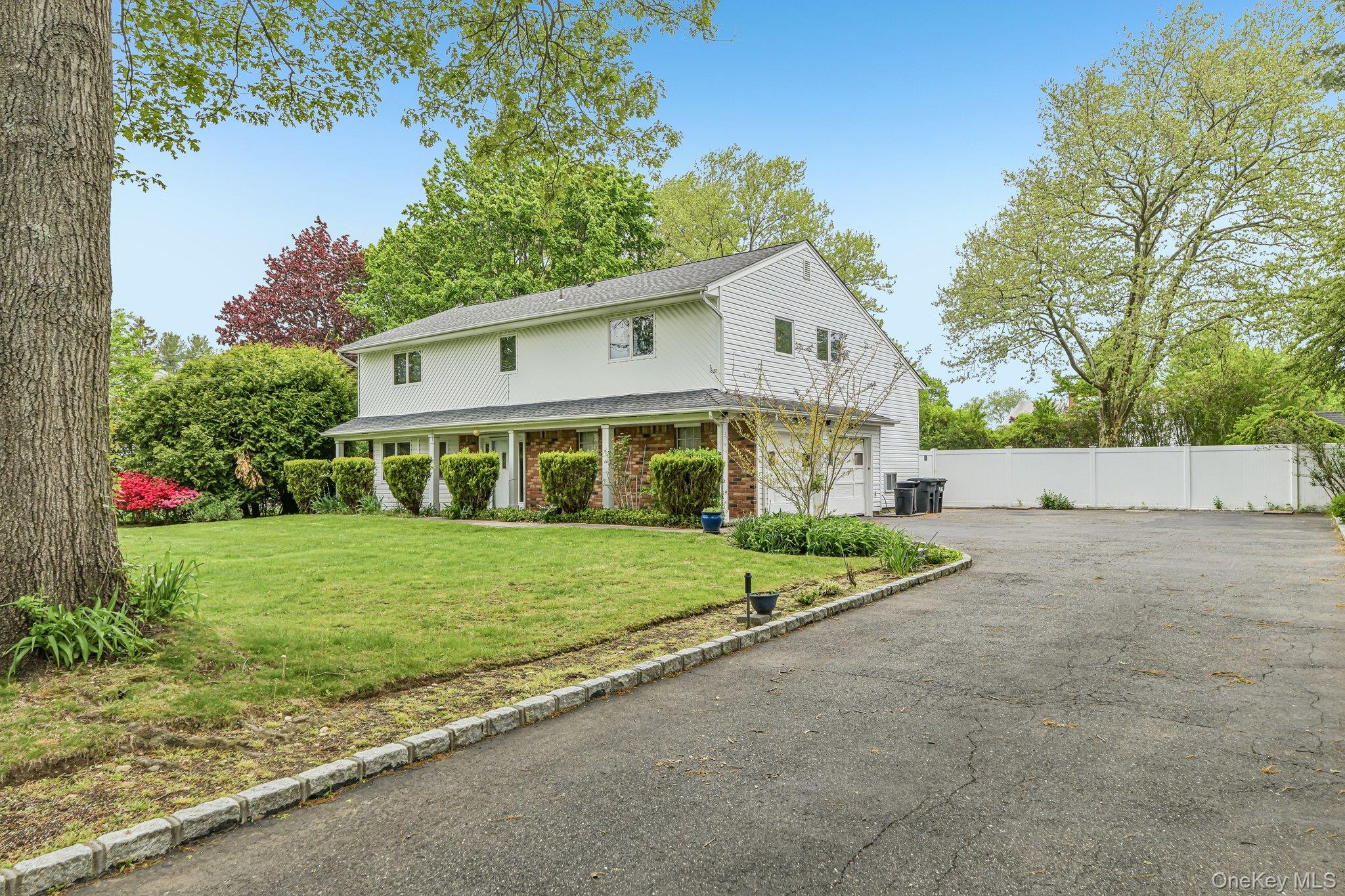 Stately home with 2.5 car garage and large driveway.