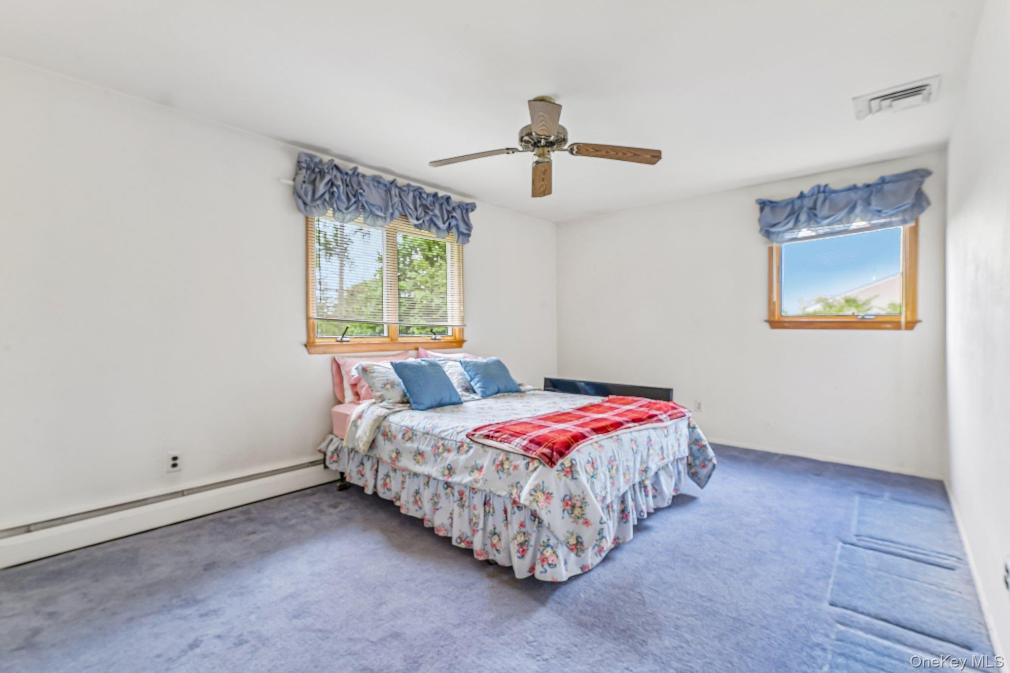 237 Cedar Road East Northport, NY 11731 - Photo 28 of 45 Spacious bedroom with hardwood floors under carpets. Ceiling fan. Double closet.