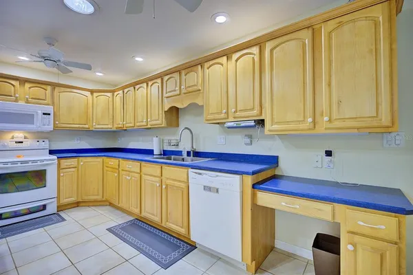 a kitchen with stainless steel appliances granite countertop a sink counter space cabinets and a stove
