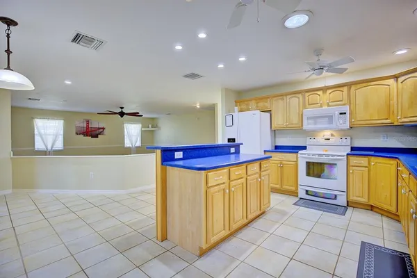 a kitchen with a refrigerator and a stove