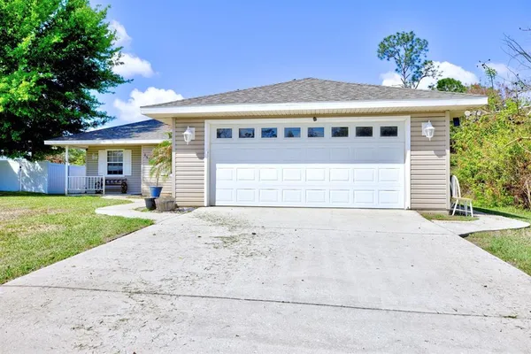 a front view of a house with a garden and yard