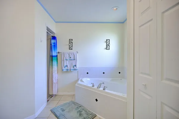 a view of a livingroom with a chandelier fan and a kitchen