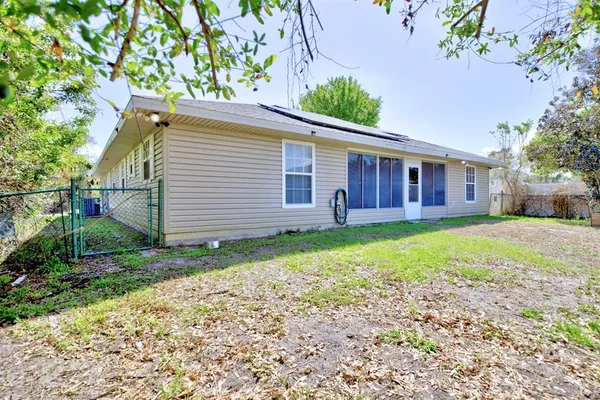 a view of a house with a yard and a garden