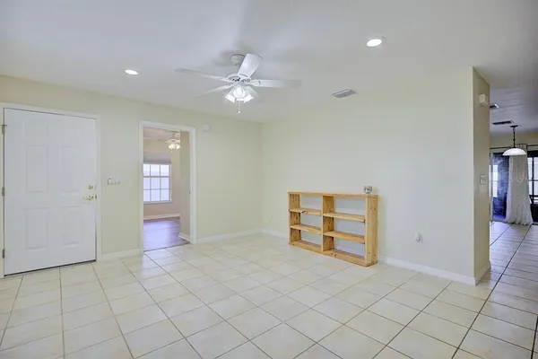 an empty room with closet and fan
