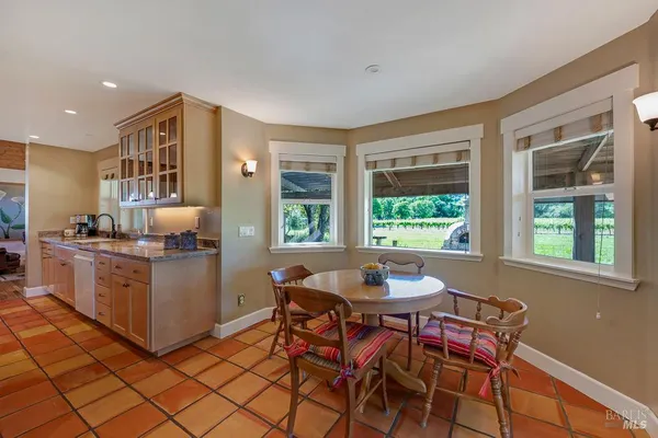 a kitchen with a table chairs and a window