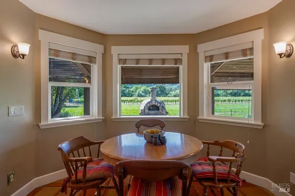 a view of a dining room with a table and chairs