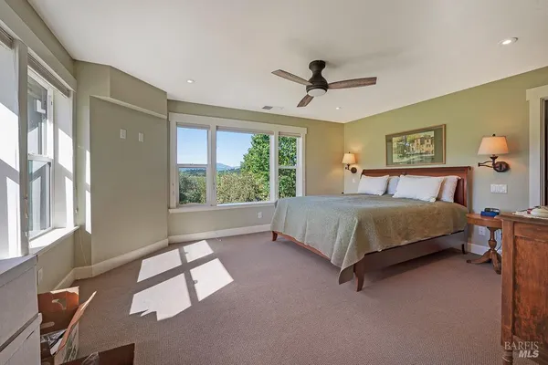a bedroom with a large bed and a window