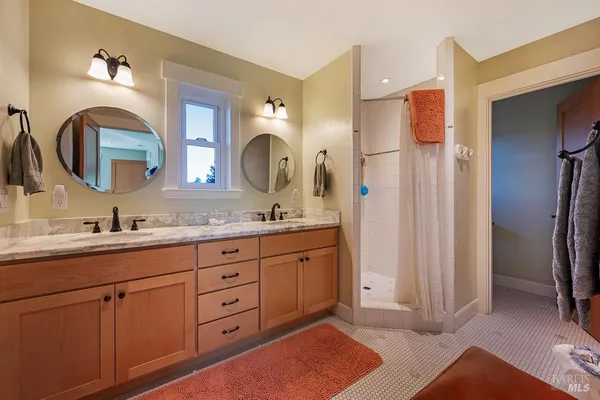 a spacious bathroom with a double vanity sink double and a mirror