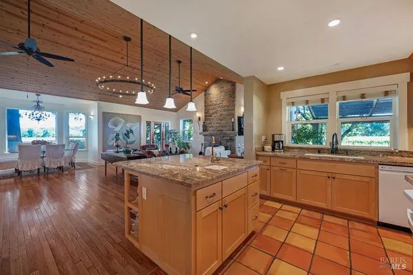 a kitchen with stainless steel appliances granite countertop a stove and cabinets