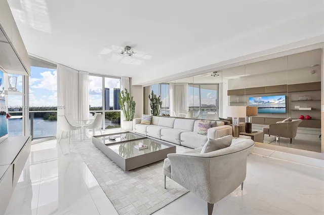 a kitchen with stainless steel appliances kitchen island granite countertop a refrigerator and a sink