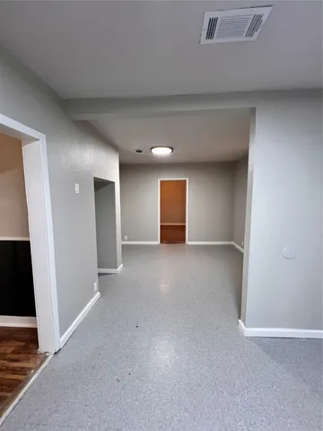 a view of an empty room and a window