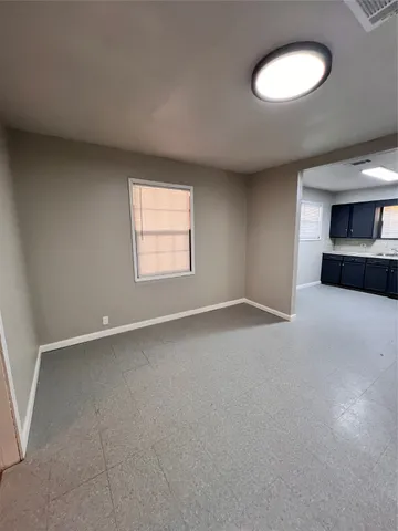 an empty room with a window and fireplace