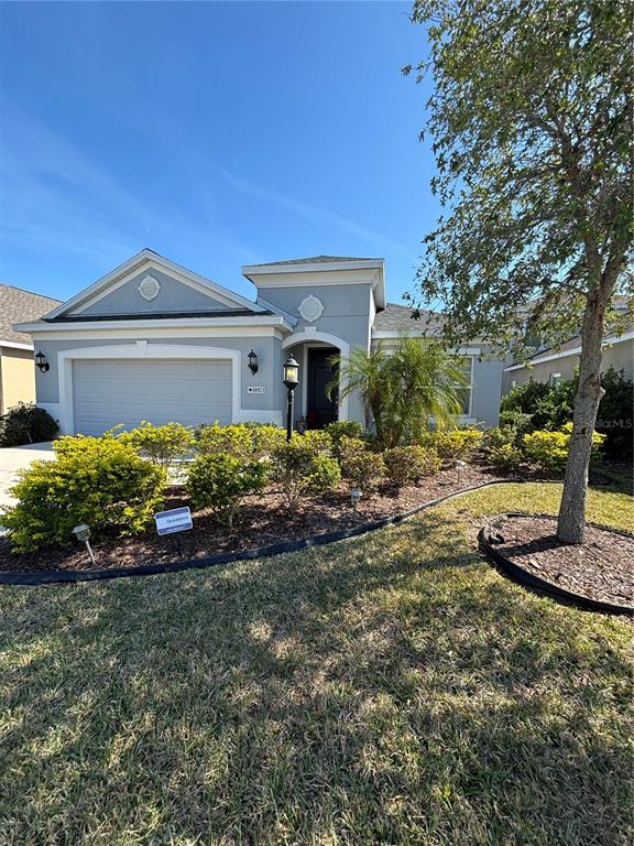 10923 Blue Magnolia Lane Parrish, FL 34219 - Photo 28 of 31 a front view of a house with a yard