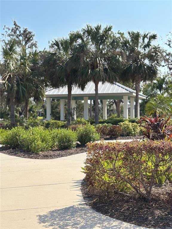 10923 Blue Magnolia Lane Parrish, FL 34219 - Photo 29 of 31 a front view of a house with a yard and potted plants