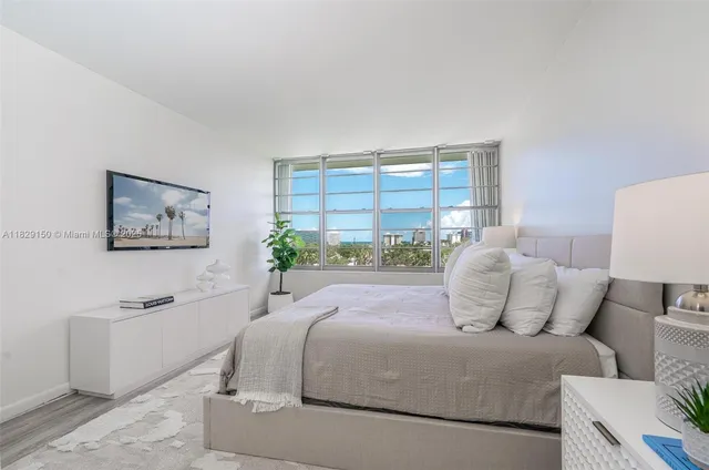 a bedroom with a large bed and a couch