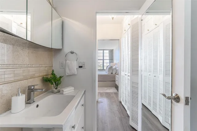 a bathroom with a sink a mirror and a shower