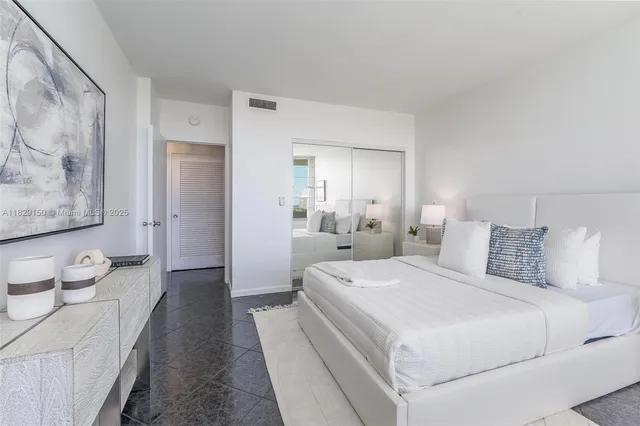 a room with a bed and a view of bathroom