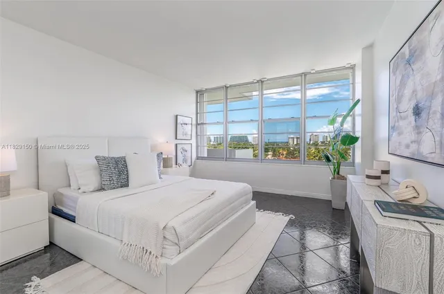 a bedroom with a large bed and a window