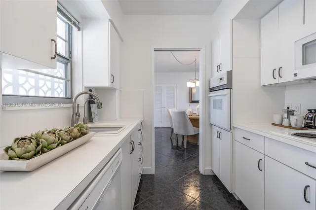 a kitchen with a sink stove and cabinets