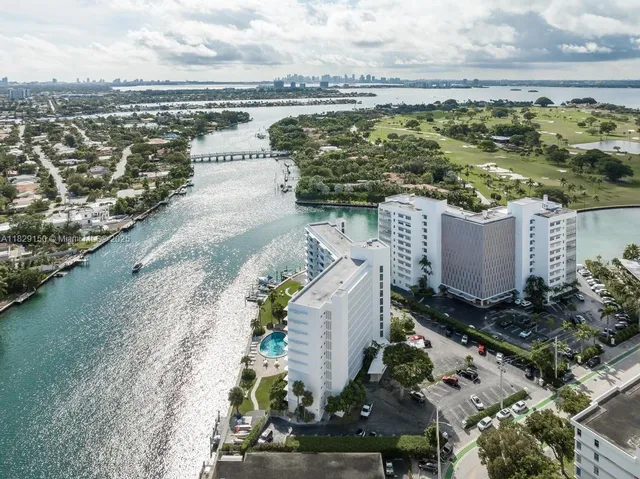 an aerial view of a house with a yard and lake view