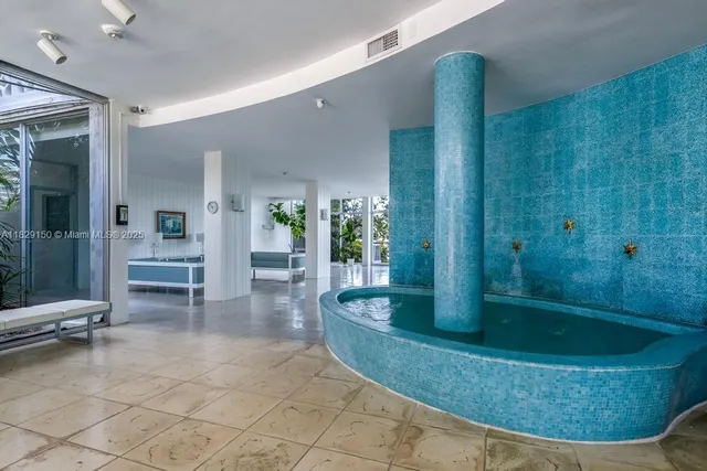 a view of a bathroom with a tub and shower