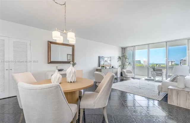 a view of a dining room with furniture wooden floor and a chandelier
