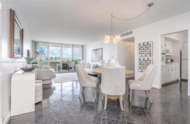 a dining room with furniture a chandelier and window