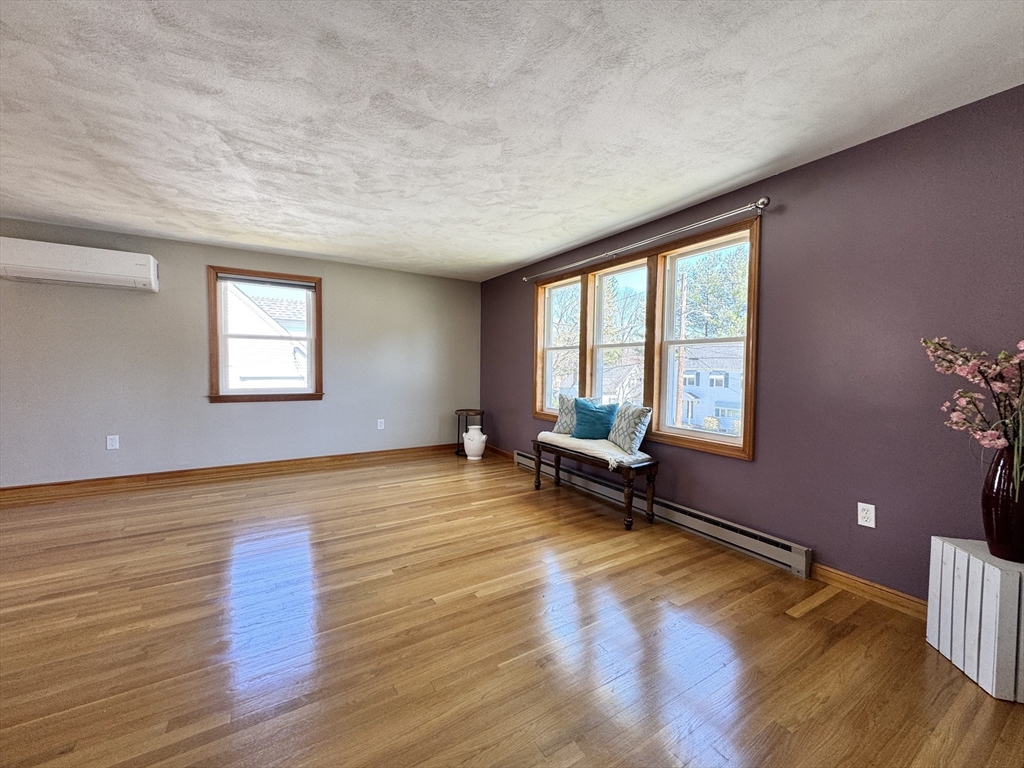 14 Maxdale Road Worcester, MA 01602 - Photo 14 of 42 a view of an empty room with a window and wooden floor