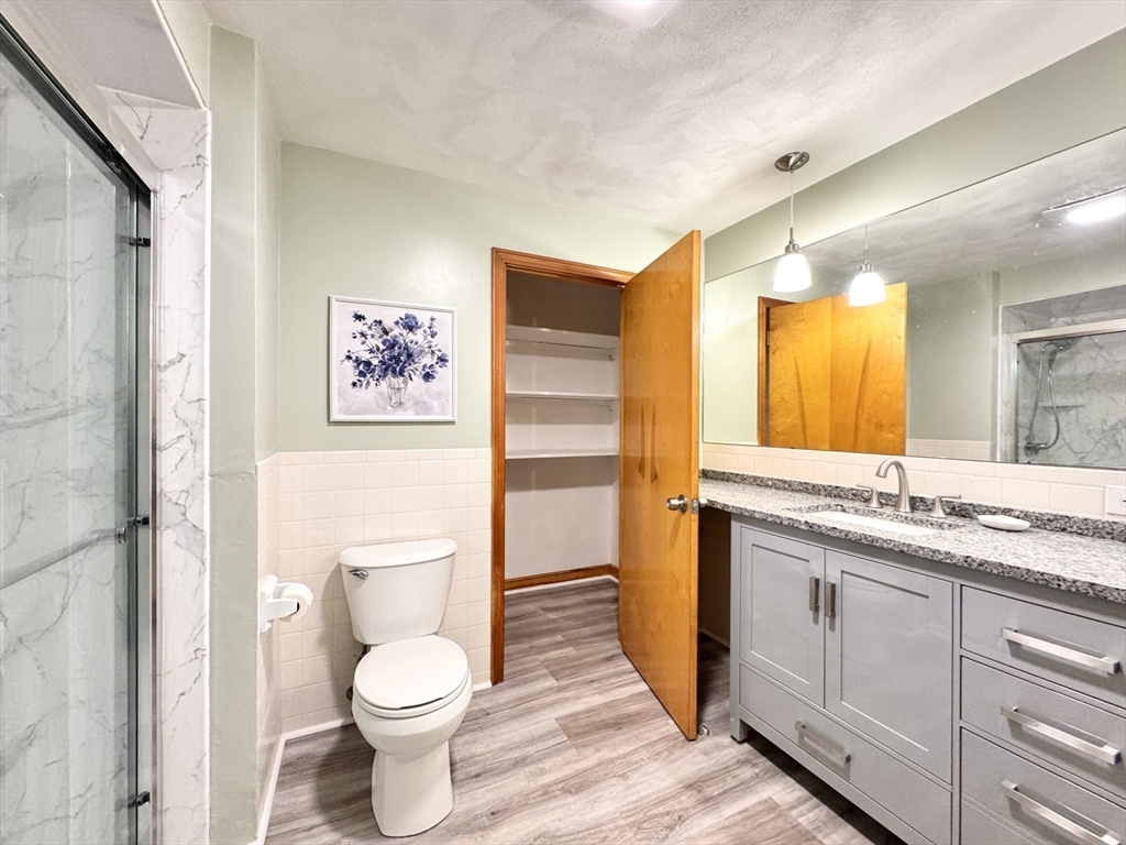 14 Maxdale Road Worcester, MA 01602 - Photo 15 of 42 a bathroom with a granite countertop toilet sink and a mirror