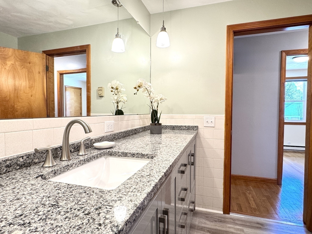 14 Maxdale Road Worcester, MA 01602 - Photo 16 of 42 a bathroom with a granite countertop sink and a mirror