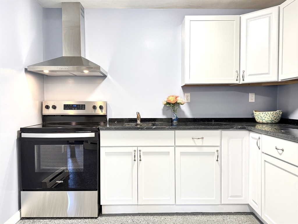 14 Maxdale Road Worcester, MA 01602 - Photo 28 of 42 a kitchen with a stove and white cabinets