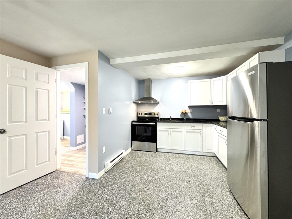 14 Maxdale Road Worcester, MA 01602 - Photo 29 of 42 a kitchen with a refrigerator and white cabinets