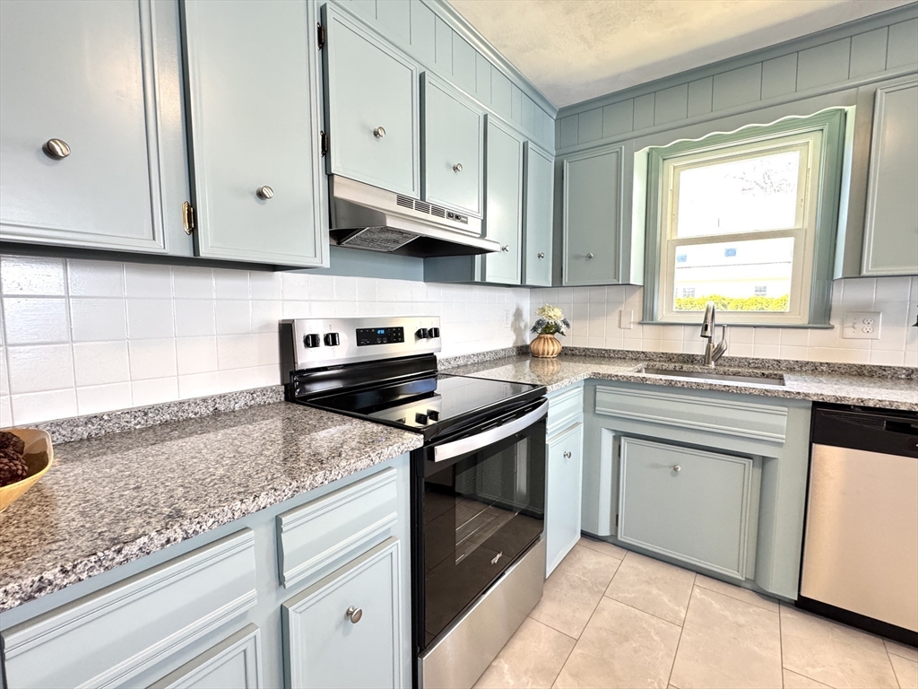 14 Maxdale Road Worcester, MA 01602 - Photo 9 of 42 a kitchen with stainless steel appliances granite countertop white cabinets and a stove a sink
