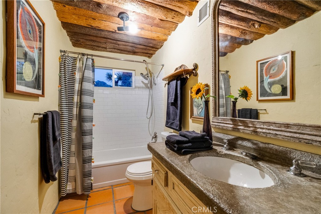 62238 Rincon Road Joshua Tree, CA 92252 - Photo 11 of 60 a bathroom with a granite countertop sink and a mirror