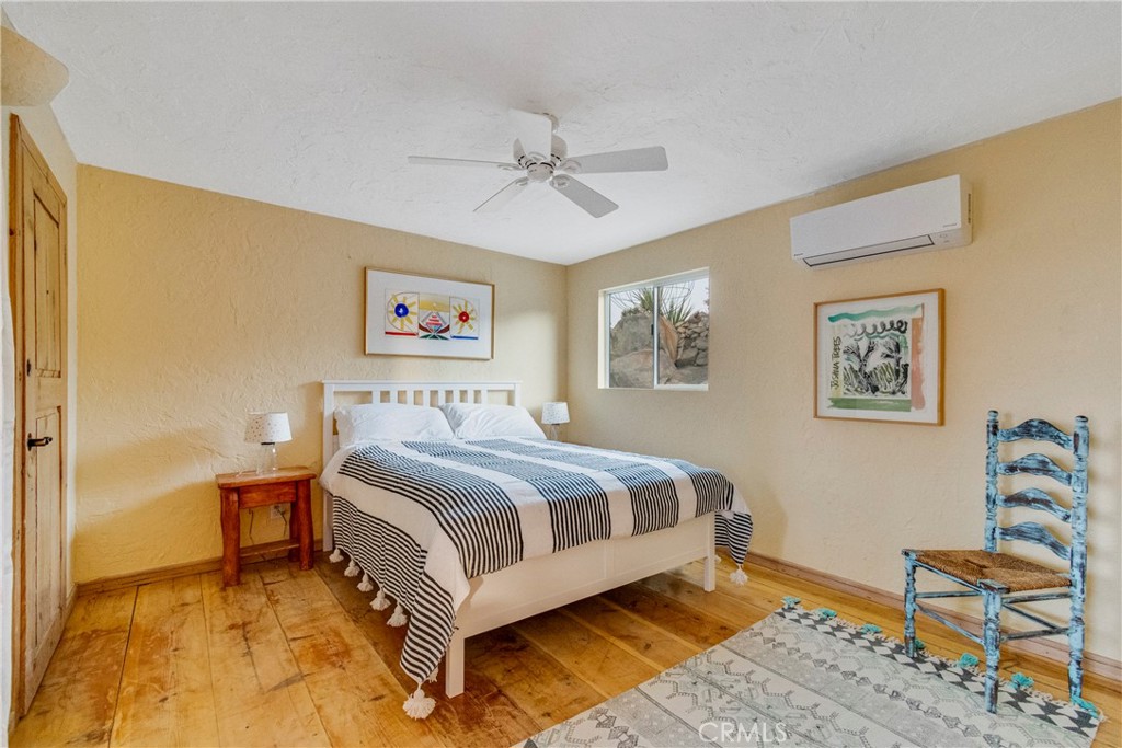 62238 Rincon Road Joshua Tree, CA 92252 - Photo 12 of 60 a spacious bedroom with a bed and furniture