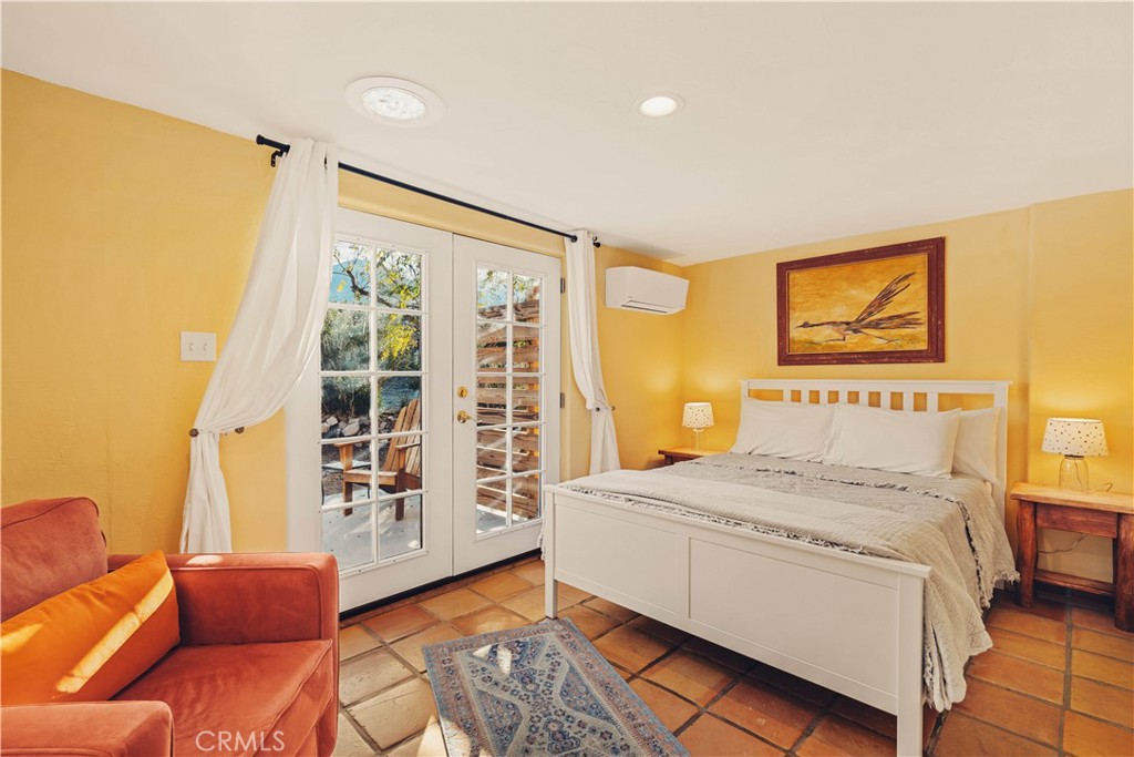 62238 Rincon Road Joshua Tree, CA 92252 - Photo 15 of 60 a bedroom with a bed couch and a window